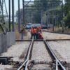Workers on train tracks using Third Rail Voltage Detector